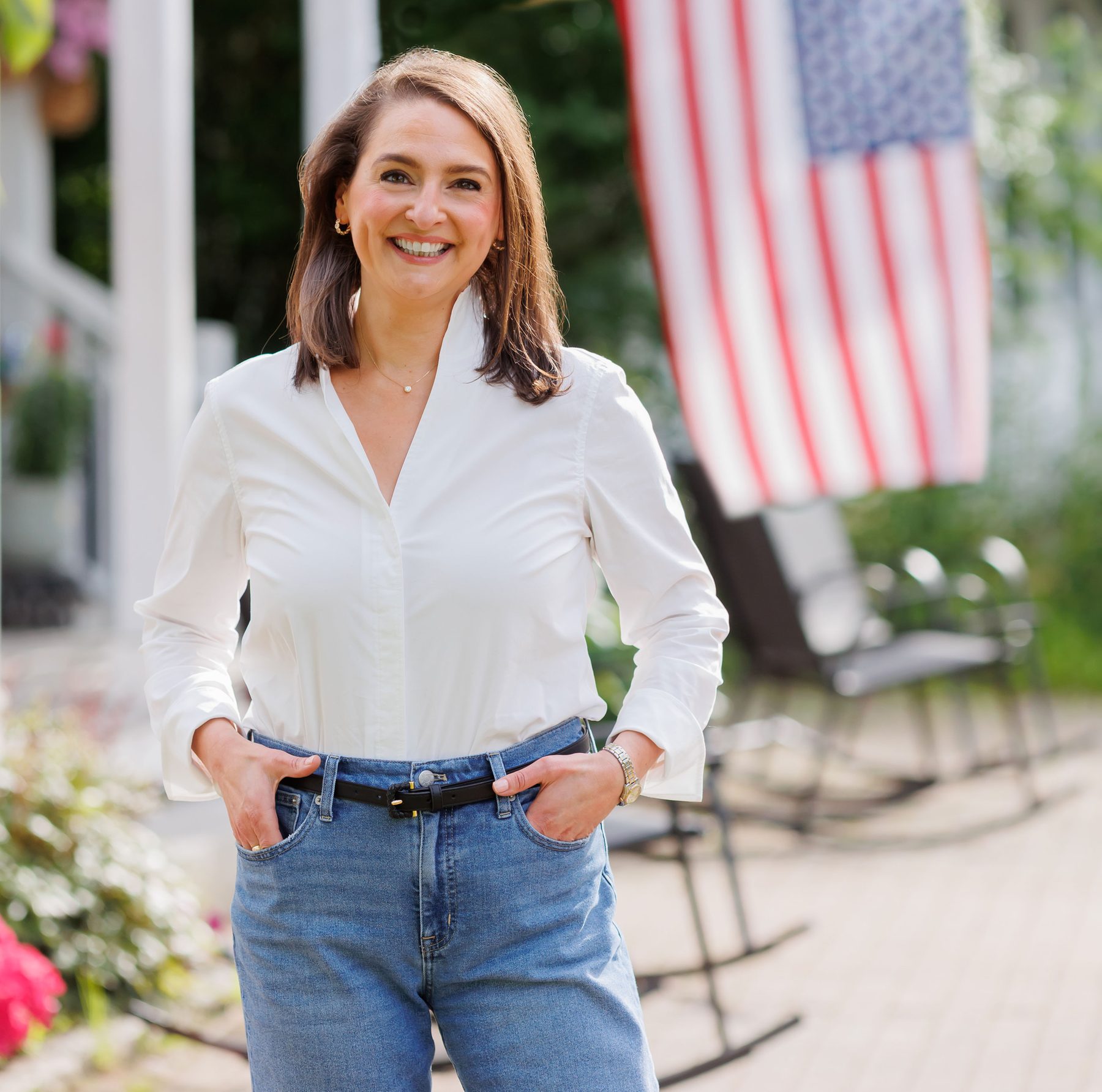 Ellen Paul standing in front of an American flag